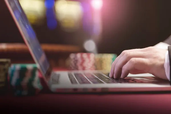 A professional dealer in a tuxedo greeting players at the roulette table, symbolizing the authentic live casino feel at 786BED.