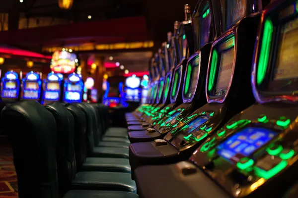 A woman in a luxurious green gown next to an ornate roulette wheel, capturing the upscale casino mood of 786BED.