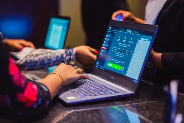 A confident dealer surrounded by casino chips inviting players to access their 786BED account, reflecting quick and easy login options.